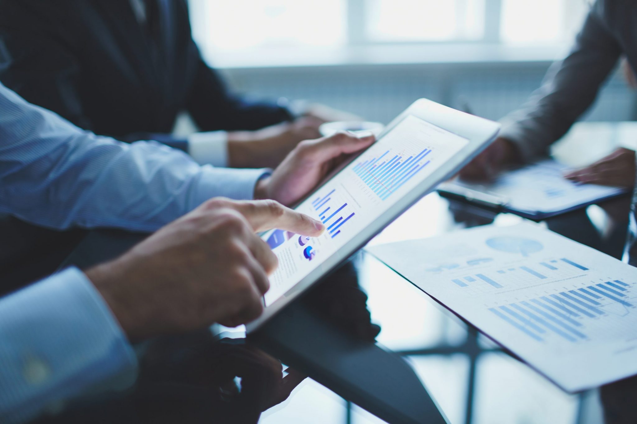 man looking at graph on tablet