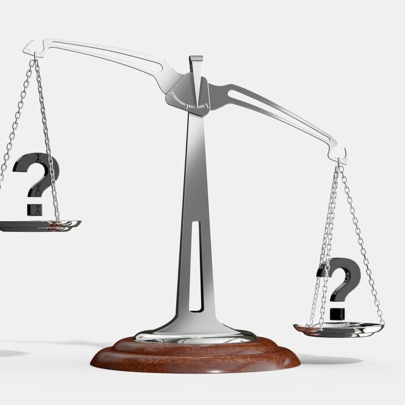 scale with question marks either side